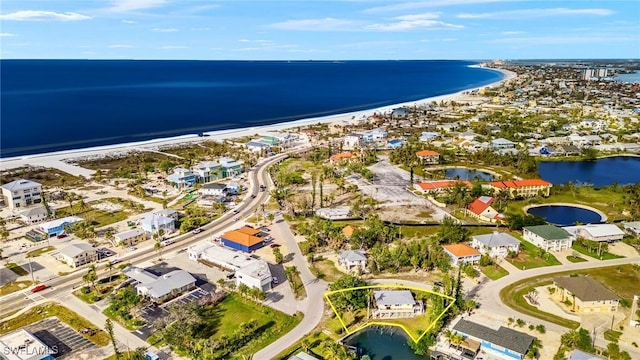 drone / aerial view with a water view and a view of the beach