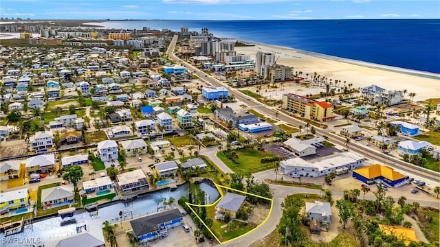 birds eye view of property featuring a city view, a water view, and a beach view