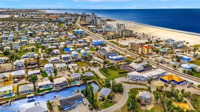 drone / aerial view featuring a water view and a beach view