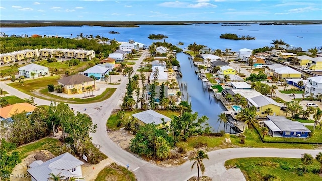 birds eye view of property with a water view and a residential view