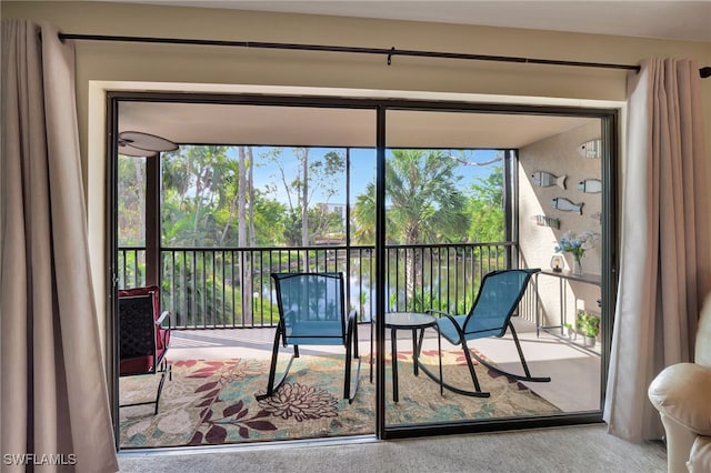 sunroom / solarium featuring a water view