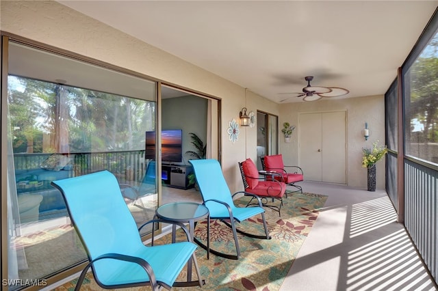 sunroom / solarium featuring ceiling fan