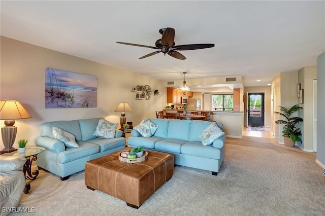 carpeted living room featuring ceiling fan