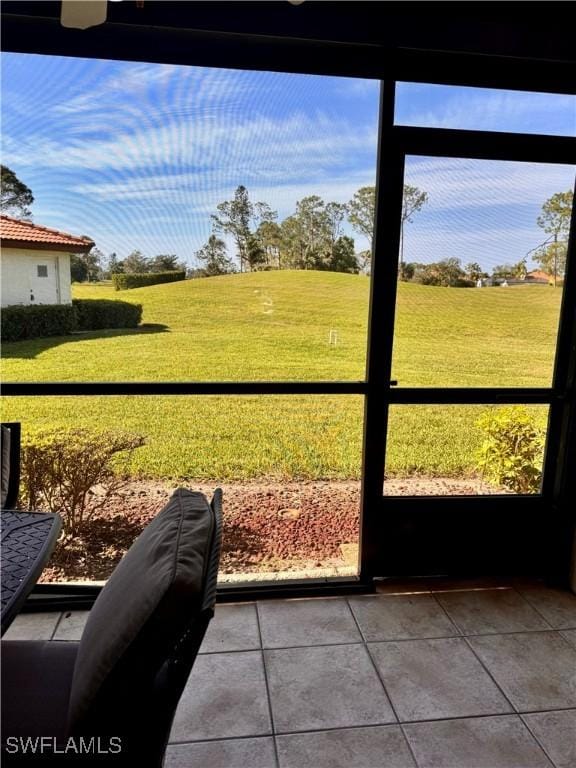 unfurnished sunroom featuring plenty of natural light and ceiling fan