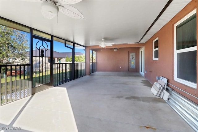 unfurnished sunroom featuring ceiling fan