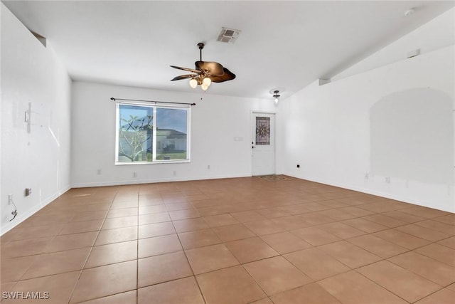 empty room featuring light tile patterned floors, ceiling fan, and lofted ceiling