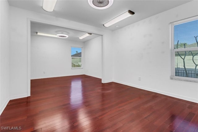 empty room with dark hardwood / wood-style floors