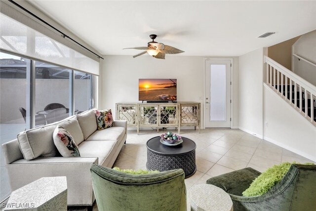 tiled living room featuring ceiling fan