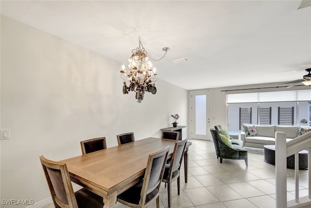 dining area featuring light tile patterned floors and ceiling fan with notable chandelier