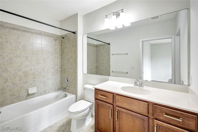 full bathroom with tiled shower / bath, vanity, tile patterned floors, and toilet