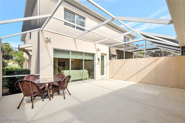 view of patio with glass enclosure