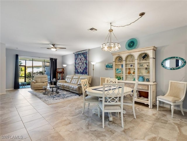 dining room featuring ceiling fan with notable chandelier