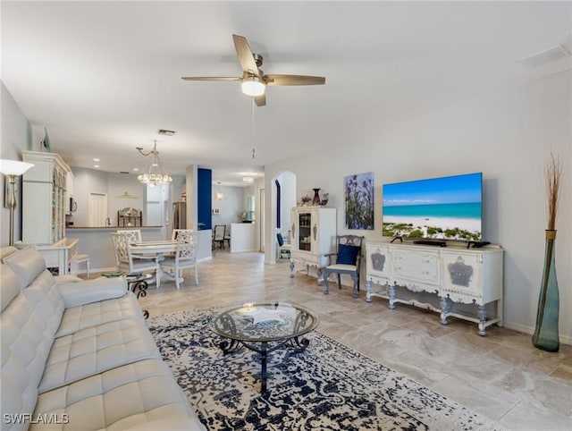 living room with ceiling fan with notable chandelier