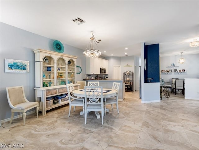 dining area with an inviting chandelier