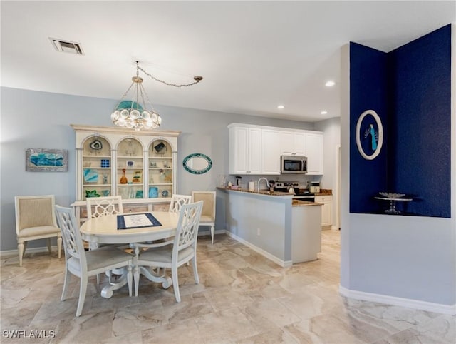 dining area featuring a notable chandelier