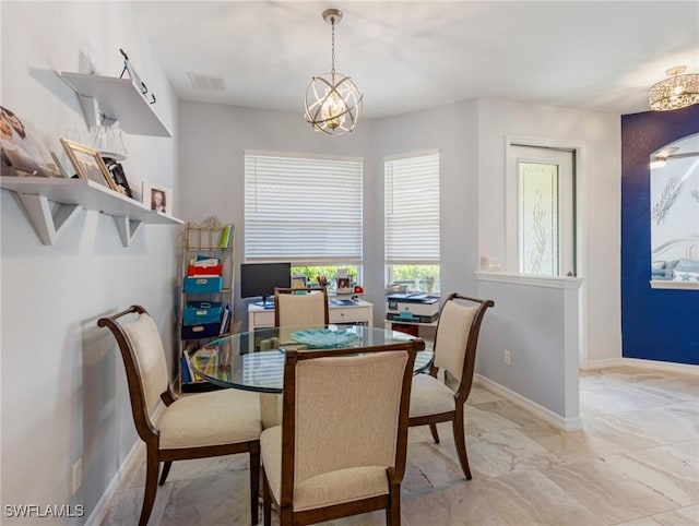 dining space featuring a chandelier