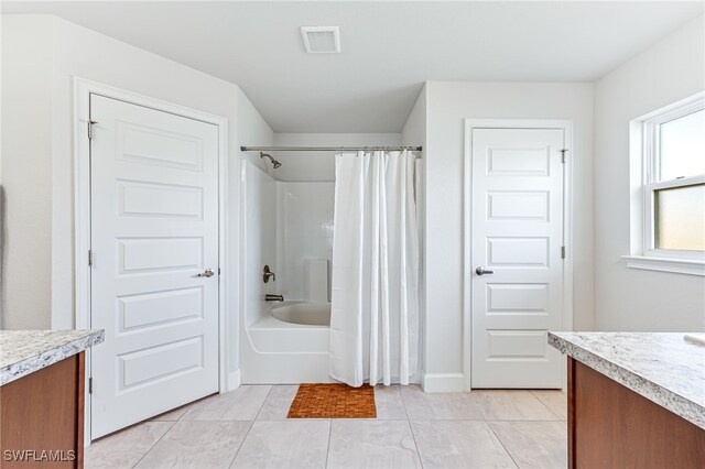 bathroom with shower / tub combo, vanity, and tile patterned floors