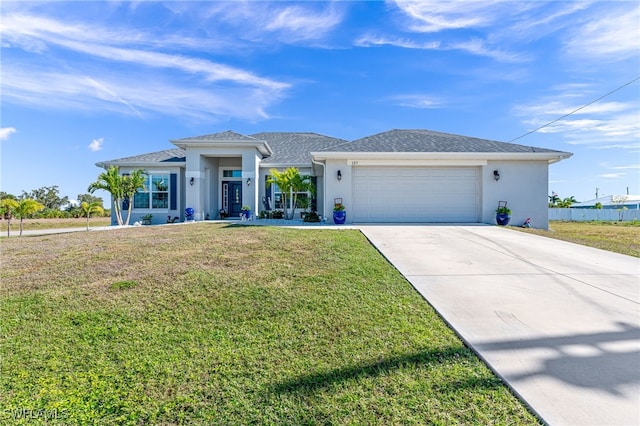 view of front of house with a garage and a front lawn