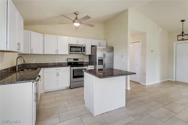 kitchen featuring appliances with stainless steel finishes, white cabinetry, a kitchen island, and sink