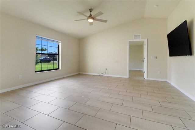 tiled spare room with ceiling fan and vaulted ceiling