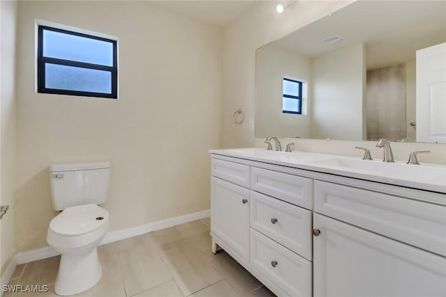 bathroom featuring tile patterned floors, vanity, and toilet