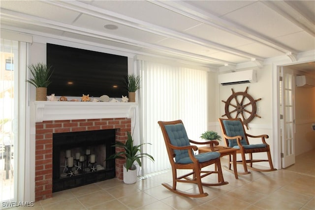 sitting room with light tile patterned floors, a wall mounted air conditioner, and a brick fireplace