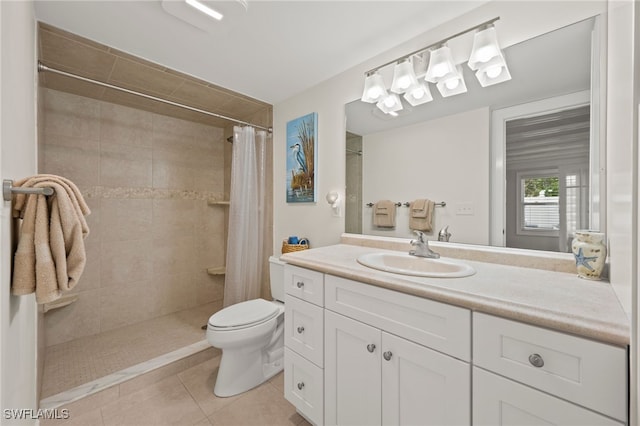 bathroom with tile patterned floors, vanity, curtained shower, and toilet