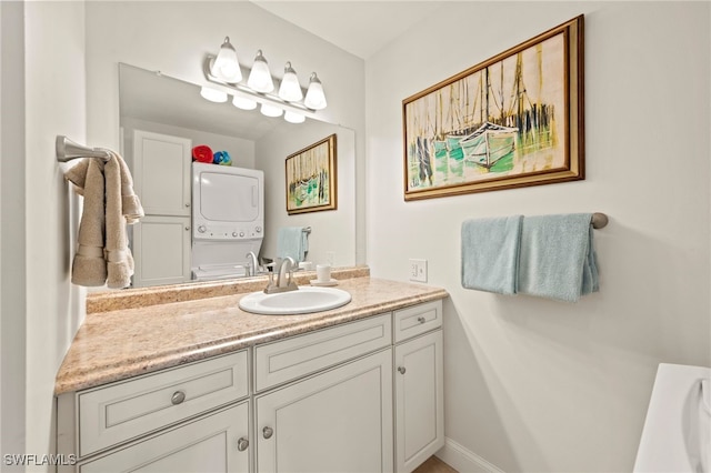 bathroom with vanity and stacked washing maching and dryer