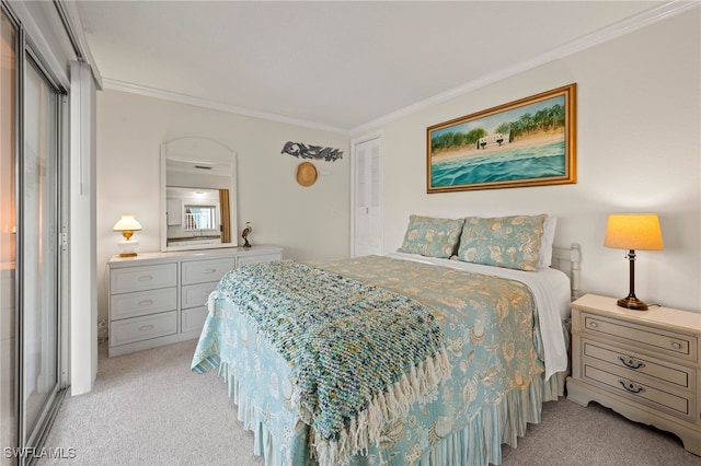 carpeted bedroom featuring crown molding and a closet