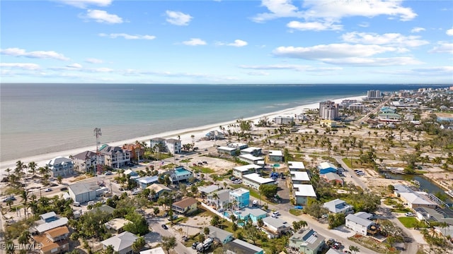 birds eye view of property with a beach view and a water view