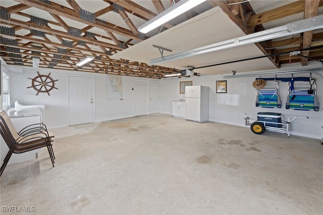 garage with white fridge and a garage door opener