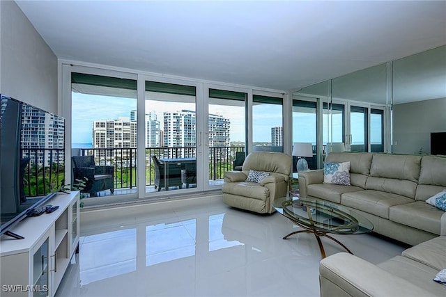 living room with light tile patterned floors and a wall of windows