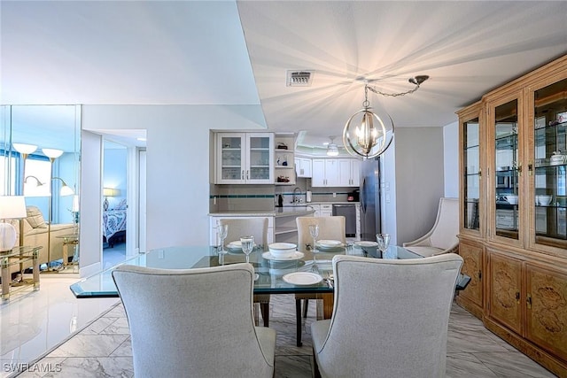 dining room with sink and a chandelier