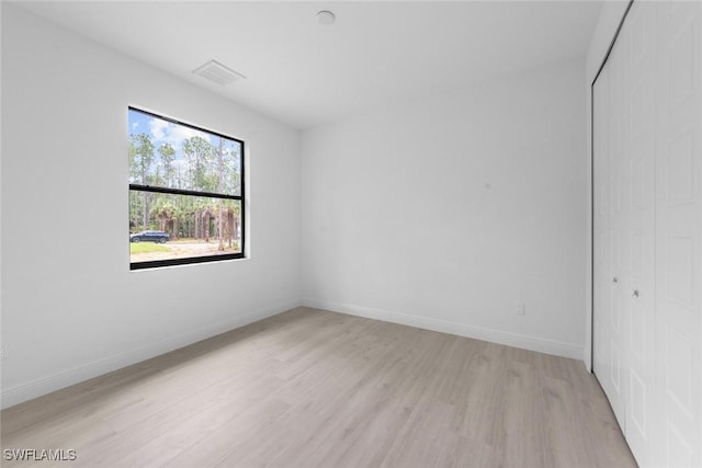 unfurnished room featuring light hardwood / wood-style floors