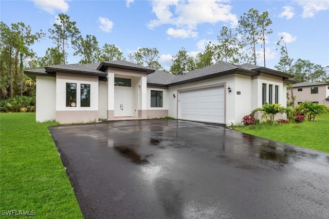 view of front facade with a front yard and a garage