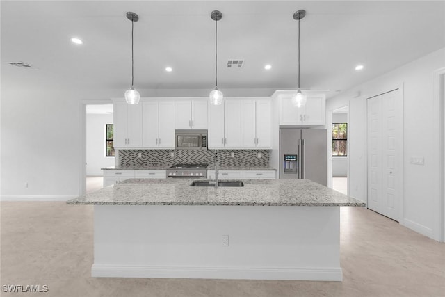 kitchen featuring a kitchen island with sink, white cabinetry, sink, and appliances with stainless steel finishes