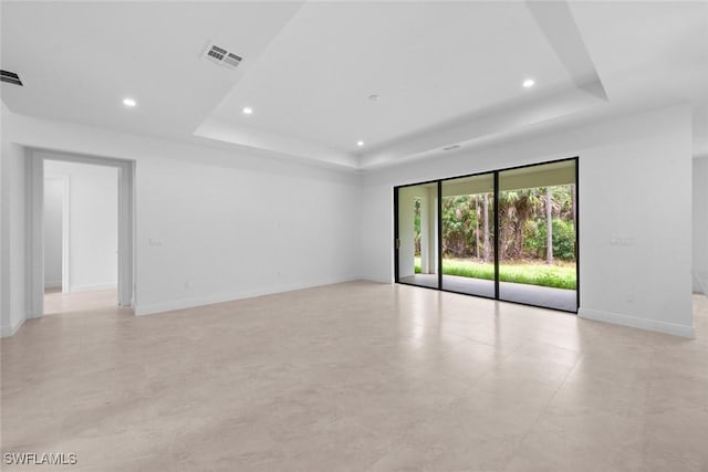 spare room with a tray ceiling