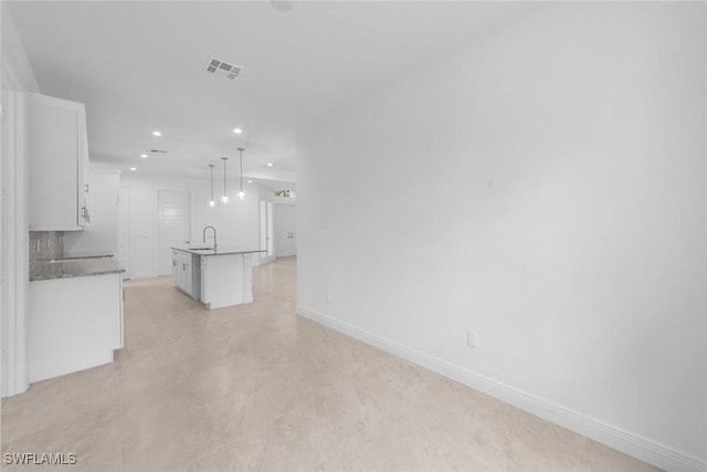 unfurnished living room featuring sink