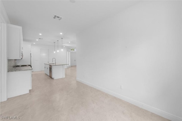 unfurnished living room with sink