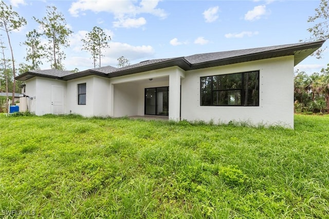 rear view of house with a lawn