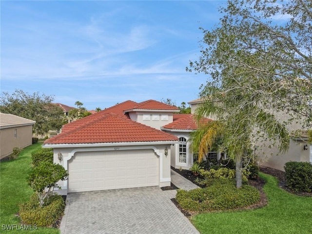 mediterranean / spanish home featuring a front lawn and a garage