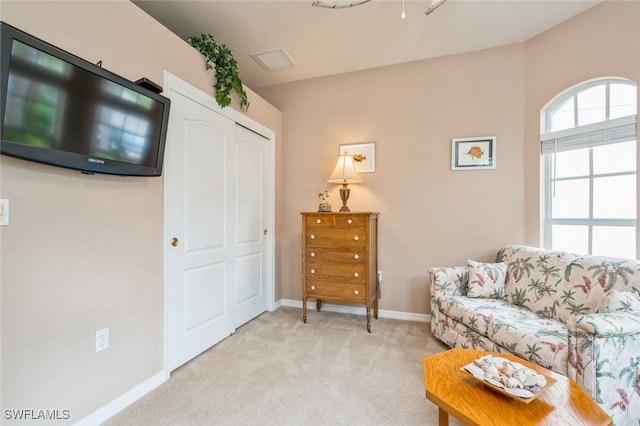 living area with light colored carpet