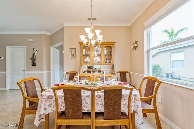 dining area featuring crown molding and a notable chandelier