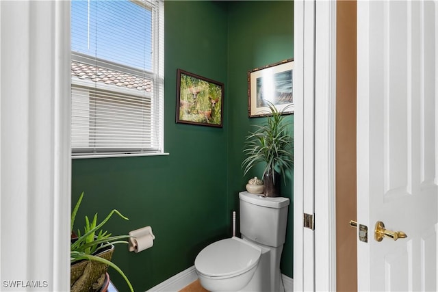 bathroom with toilet and baseboards