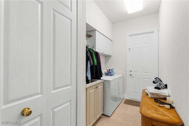 washroom featuring light tile patterned flooring, cabinets, and independent washer and dryer