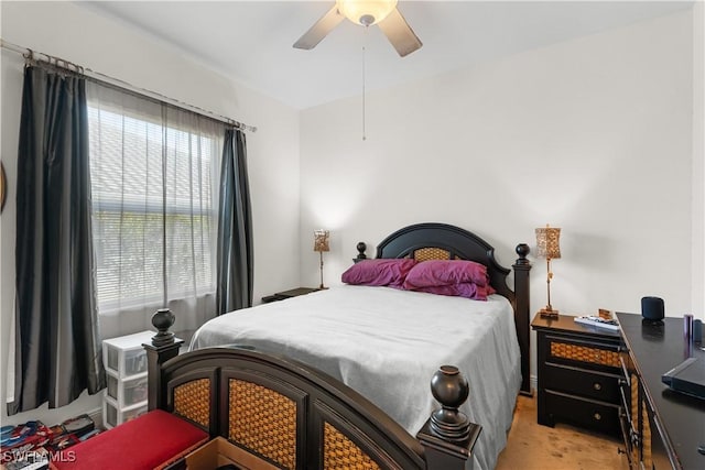 bedroom with ceiling fan and light carpet