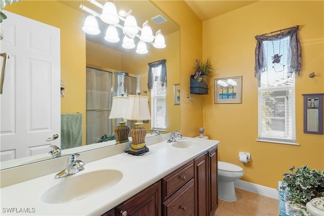 bathroom featuring tile patterned flooring, vanity, toilet, and curtained shower