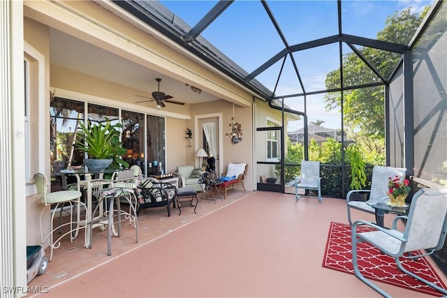 view of patio / terrace featuring glass enclosure and ceiling fan