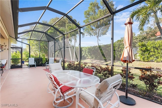 view of patio featuring glass enclosure