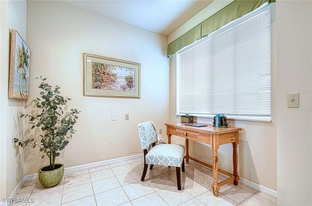 home office with light tile patterned floors and baseboards